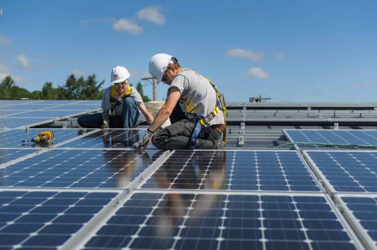 Neil Kelly's solar crew installs solar panels on a commercial roof