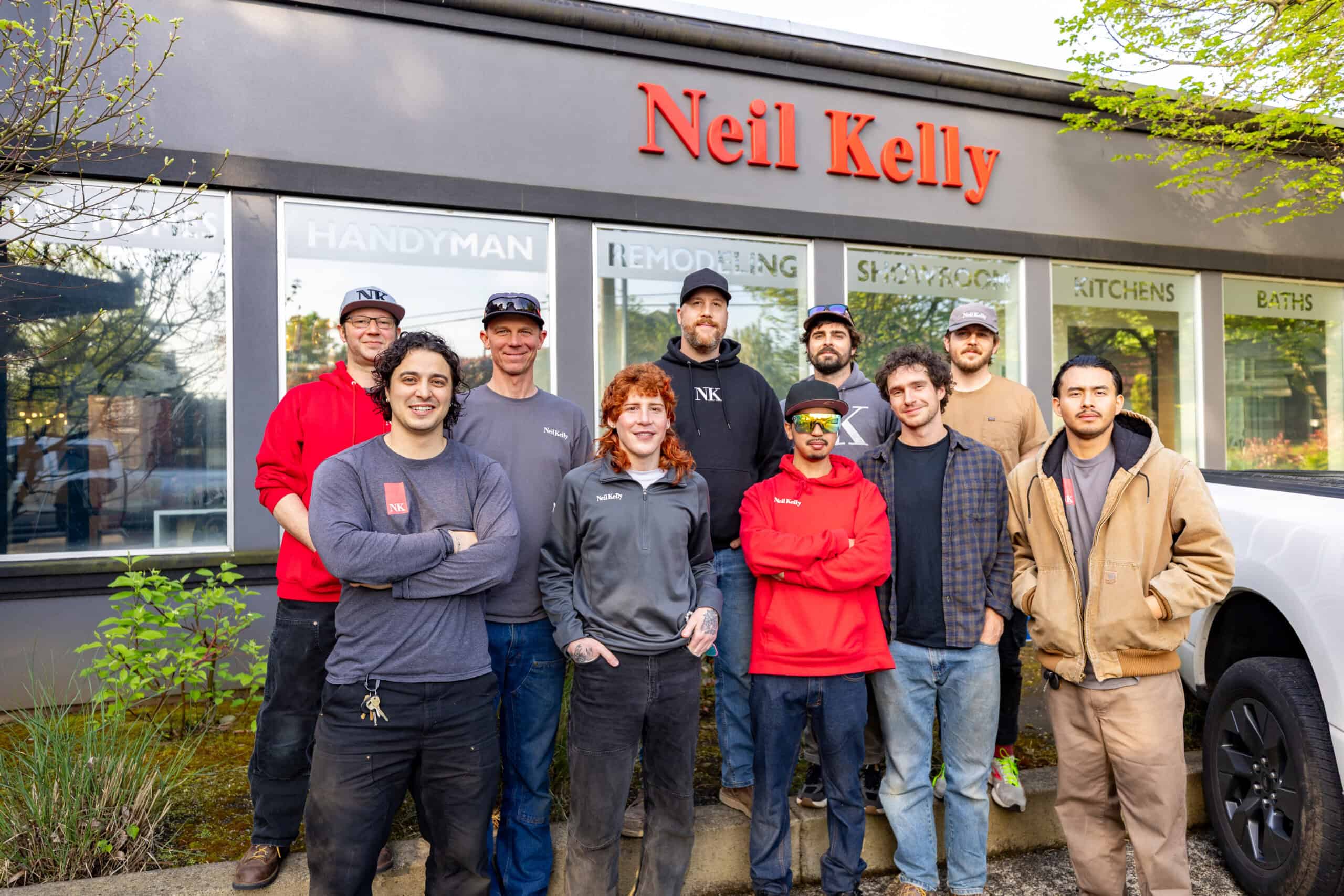 Neil Kelly Company's solar team standing as a group in front of the Neil Kelly office building in North Portland.