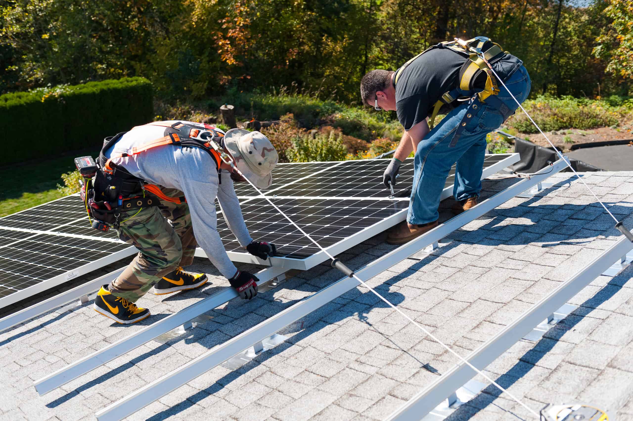 Neil Kelly solar installers mounting pv panels to a residential